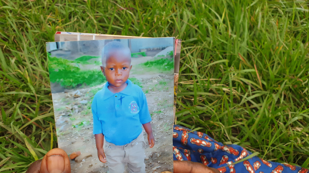 A mother holding a photo of her child